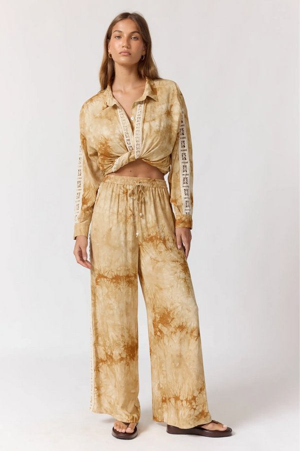 Woman wearing a tie-dye outfit on a white background