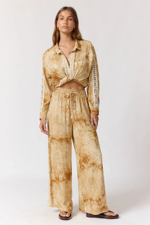 Woman wearing a tie-dye outfit on a white background