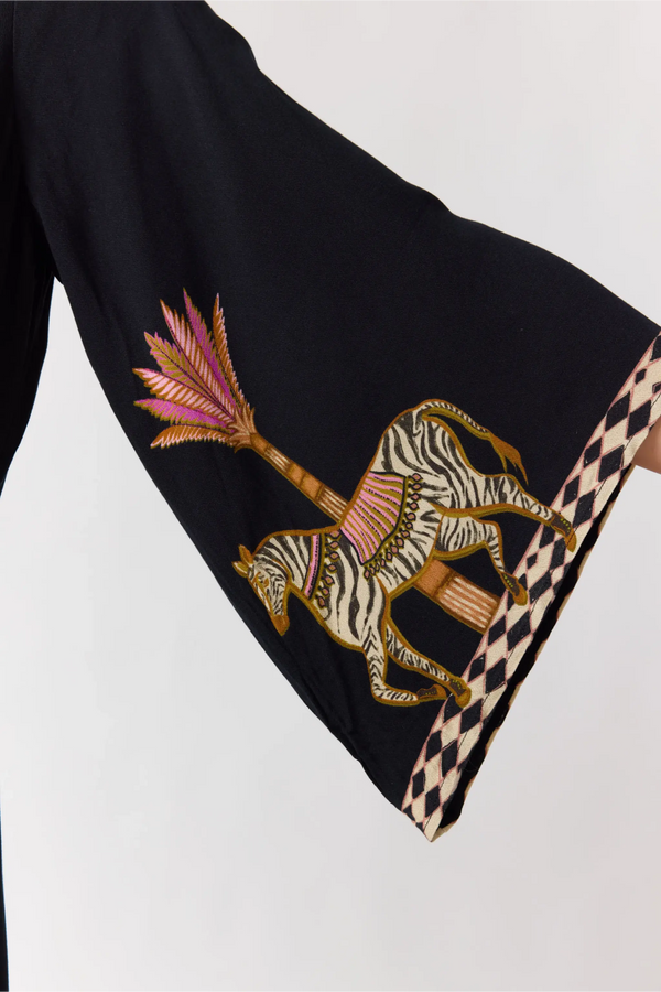 Black fabric with embroidered zebra design on a white background