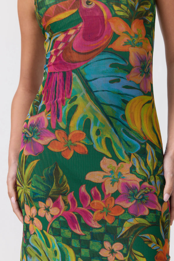 A close-up of a sleeveless dress featuring a vibrant tropical print with a pink toucan, green leaves, and colorful flowers on a dark green background.