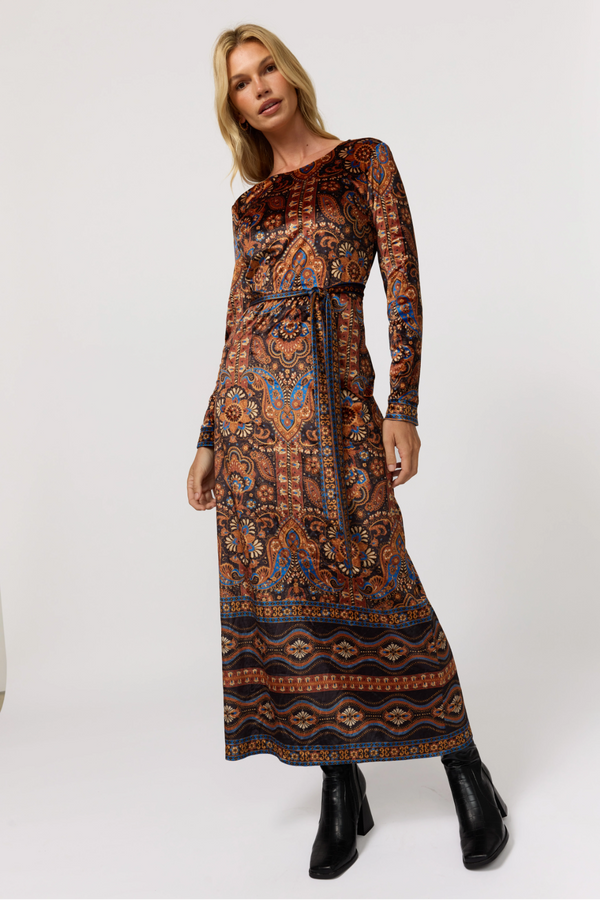 Woman wearing a patterned dress on a white background