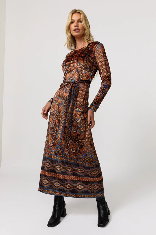 Woman wearing a patterned dress on a white background