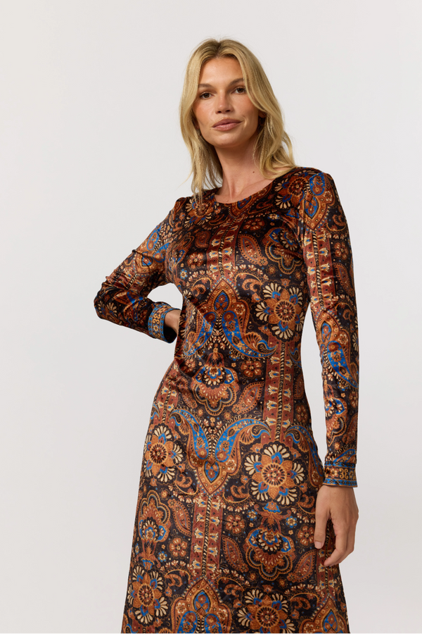 Woman wearing a patterned dress on a white background