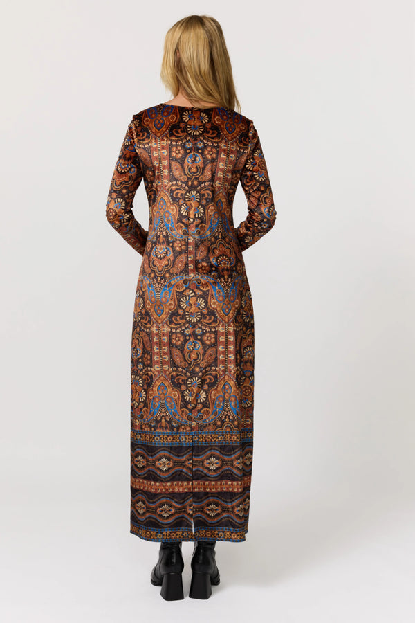 Woman wearing a patterned dress on a white background