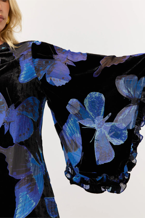 Black garment with blue butterfly patterns on a white background