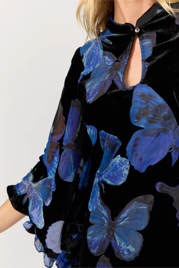 Black dress with blue butterfly patterns worn by a person