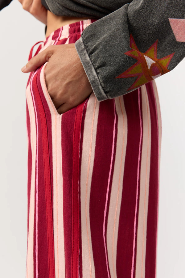 Red and white striped garment with a gray sleeve featuring star patterns.