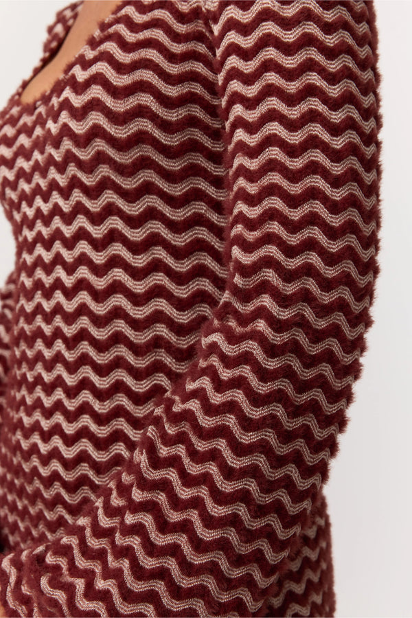 Close-up of a textured red and white patterned fabric.