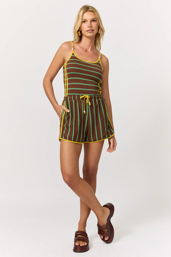 Woman wearing a striped romper on a white background