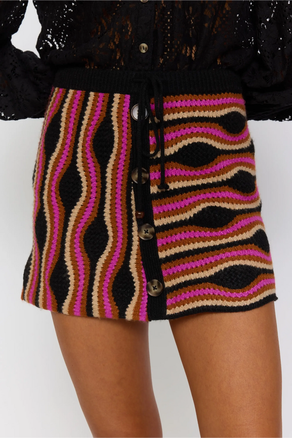 Colorful striped skirt with a black top on a white background