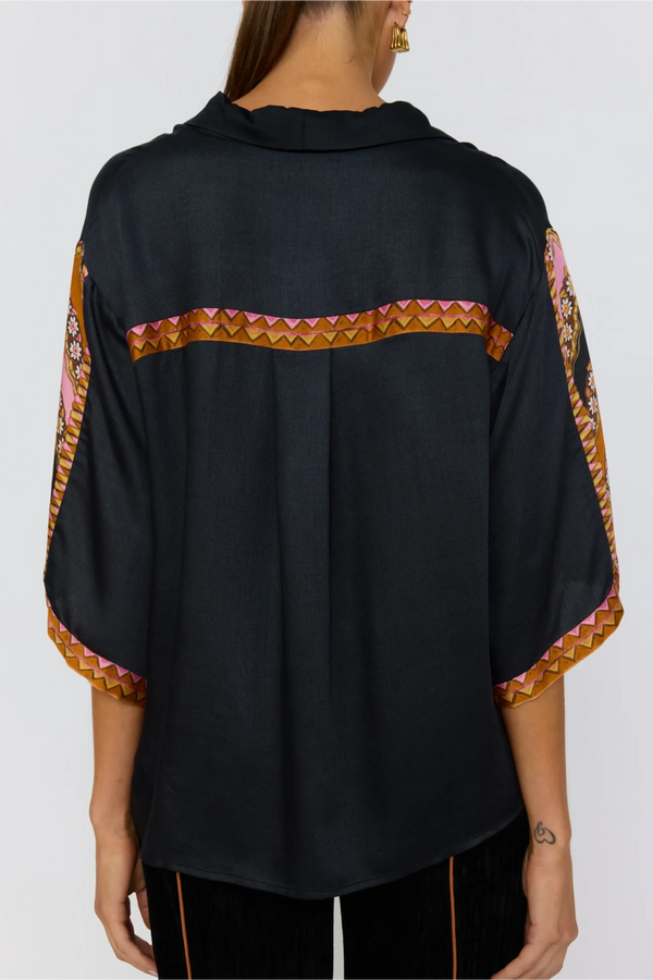 Black shirt with colorful patterned sleeves on a white background