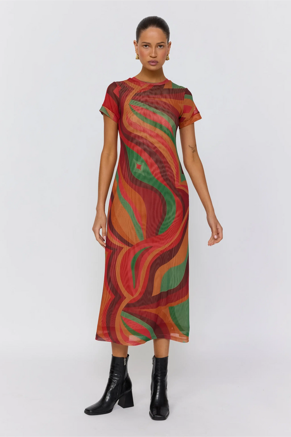 Woman wearing a patterned dress on a white background