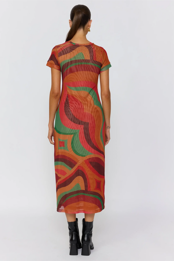 Woman wearing a colorful patterned dress on a white background