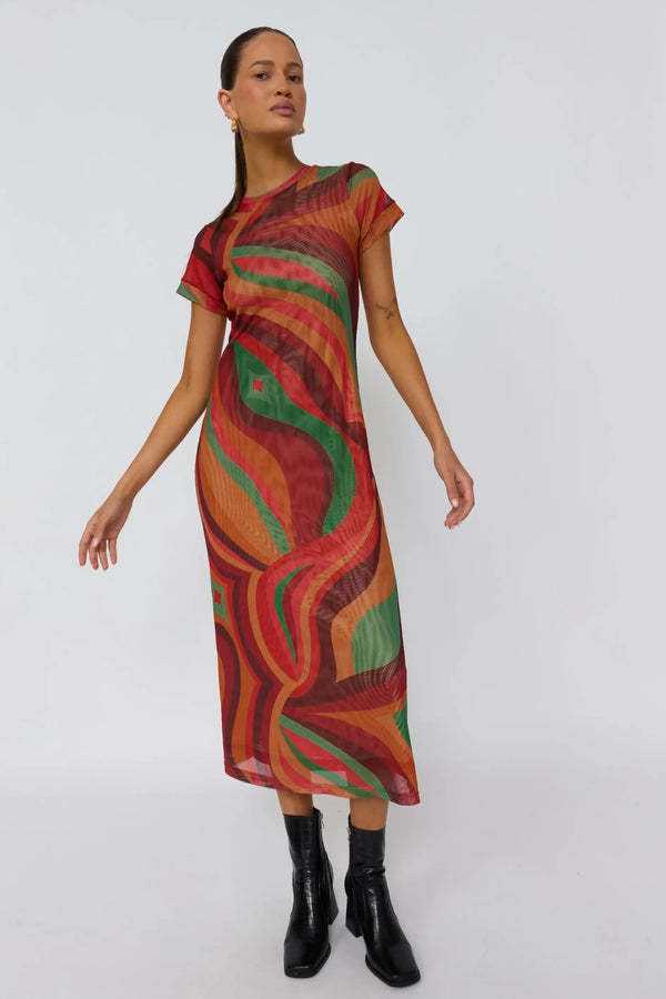 Woman wearing a colorful patterned dress on a white background