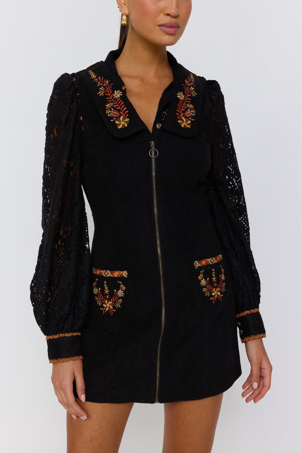 Black dress with gold embroidery on a white background