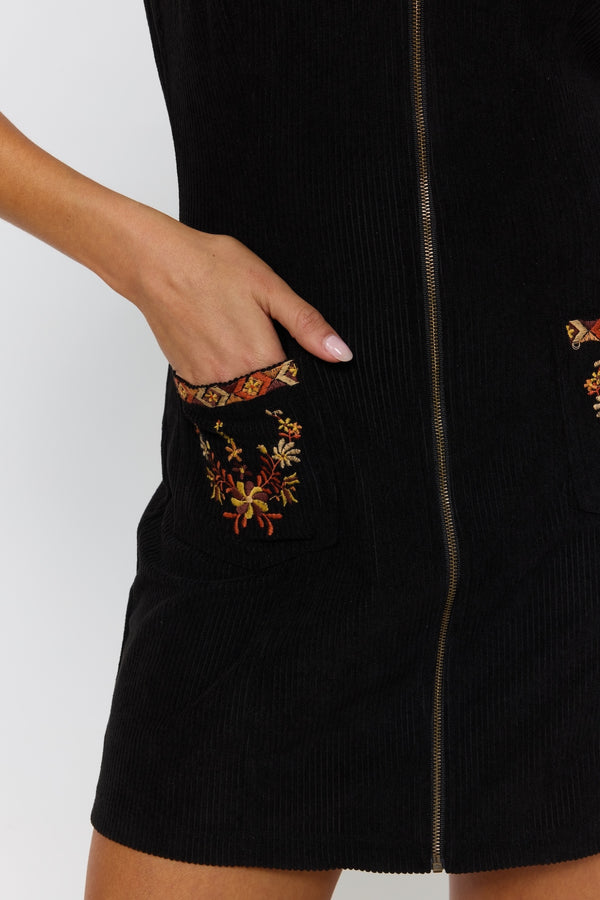 Black dress with floral embroidery on a white background