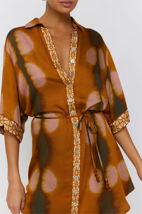 Brown patterned dress with a belt on a white background