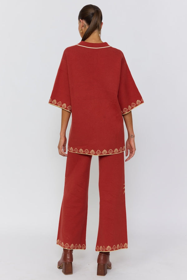 Red outfit with gold embroidery on a white background