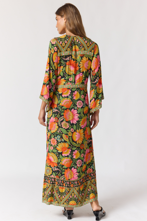 Woman wearing a colorful floral dress on a white background