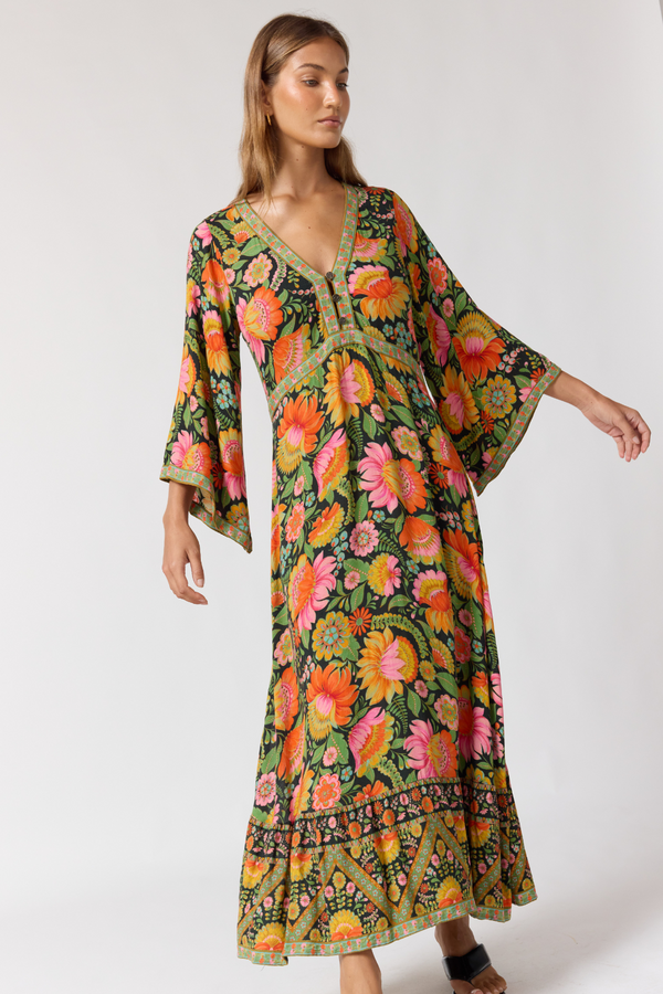 Woman wearing a colorful floral dress on a white background