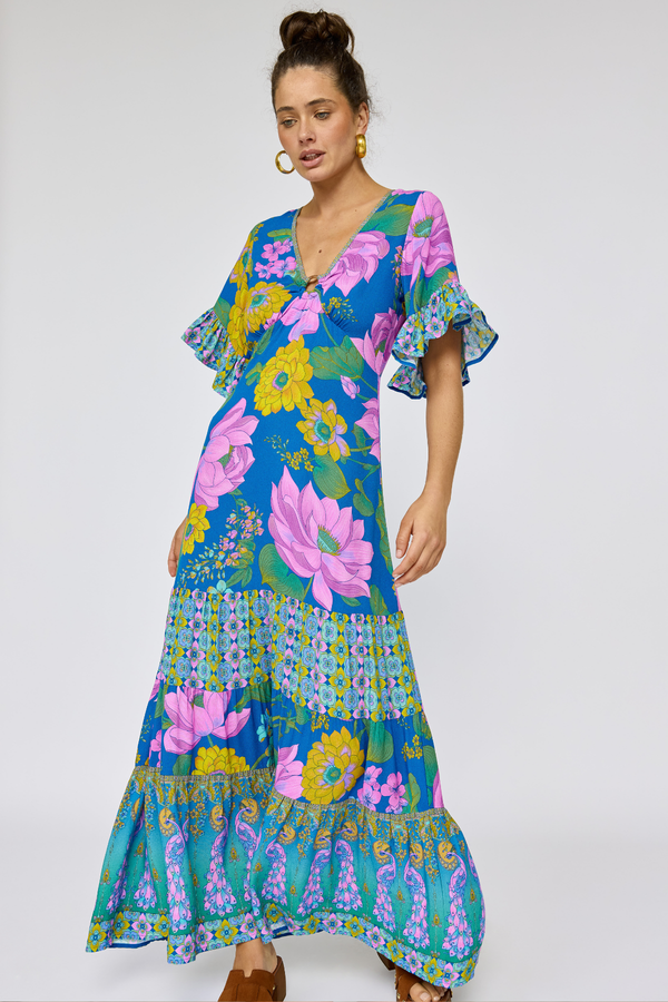 Woman wearing a colorful floral dress on a white background