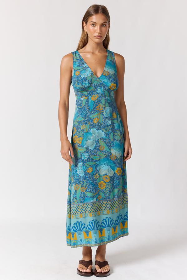 Woman wearing a blue floral dress on a white background