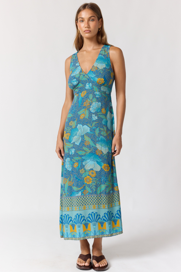 Woman wearing a blue floral dress on a white background