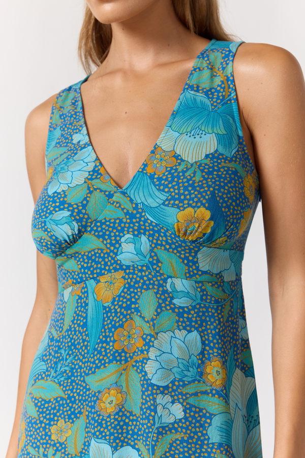 Woman wearing a blue floral dress on a white background