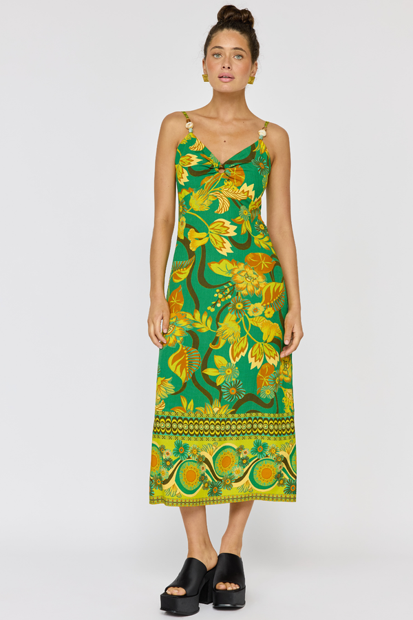 Woman wearing a green floral dress on a white background