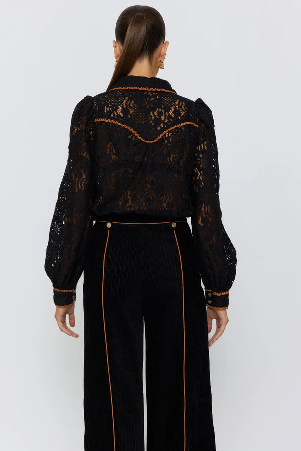 Black lace blouse with intricate detailing on a white background