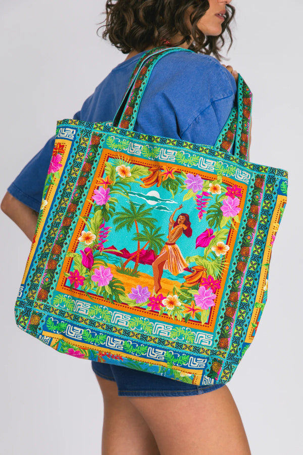 Person holding a colorful tote bag with tropical design