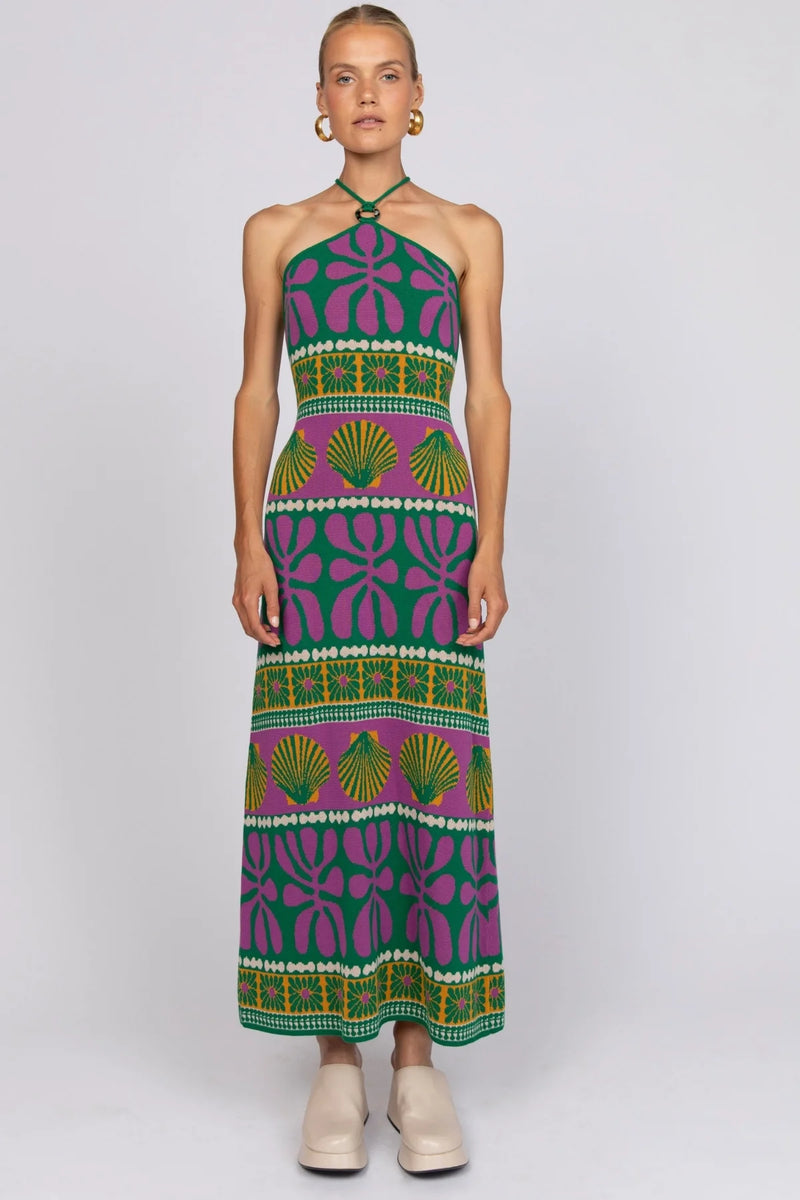 Woman wearing a colorful patterned dress on a white background