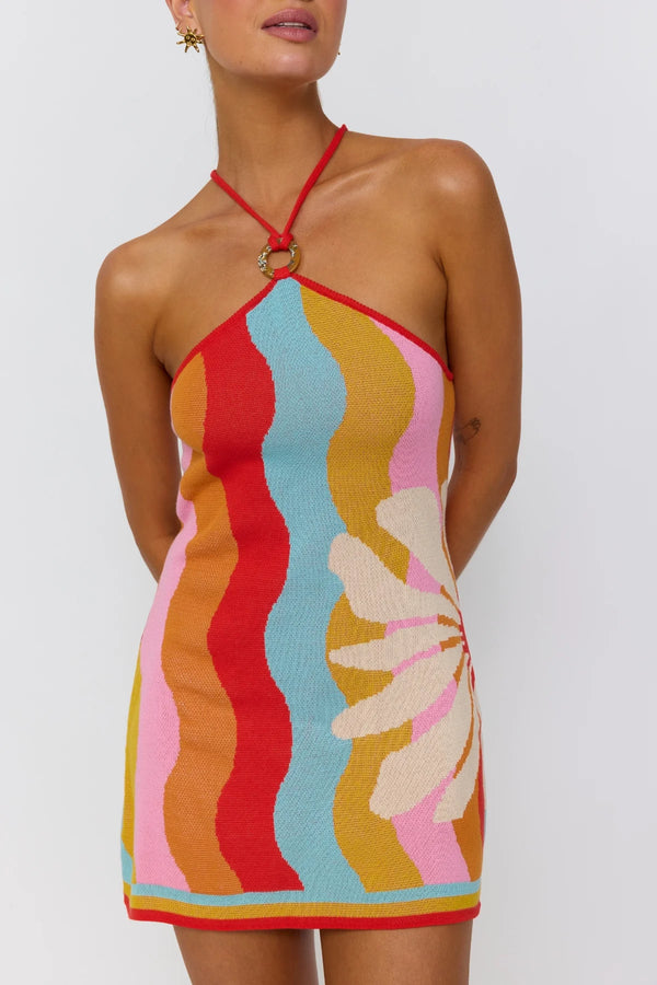 Woman wearing a colorful dress with a white background