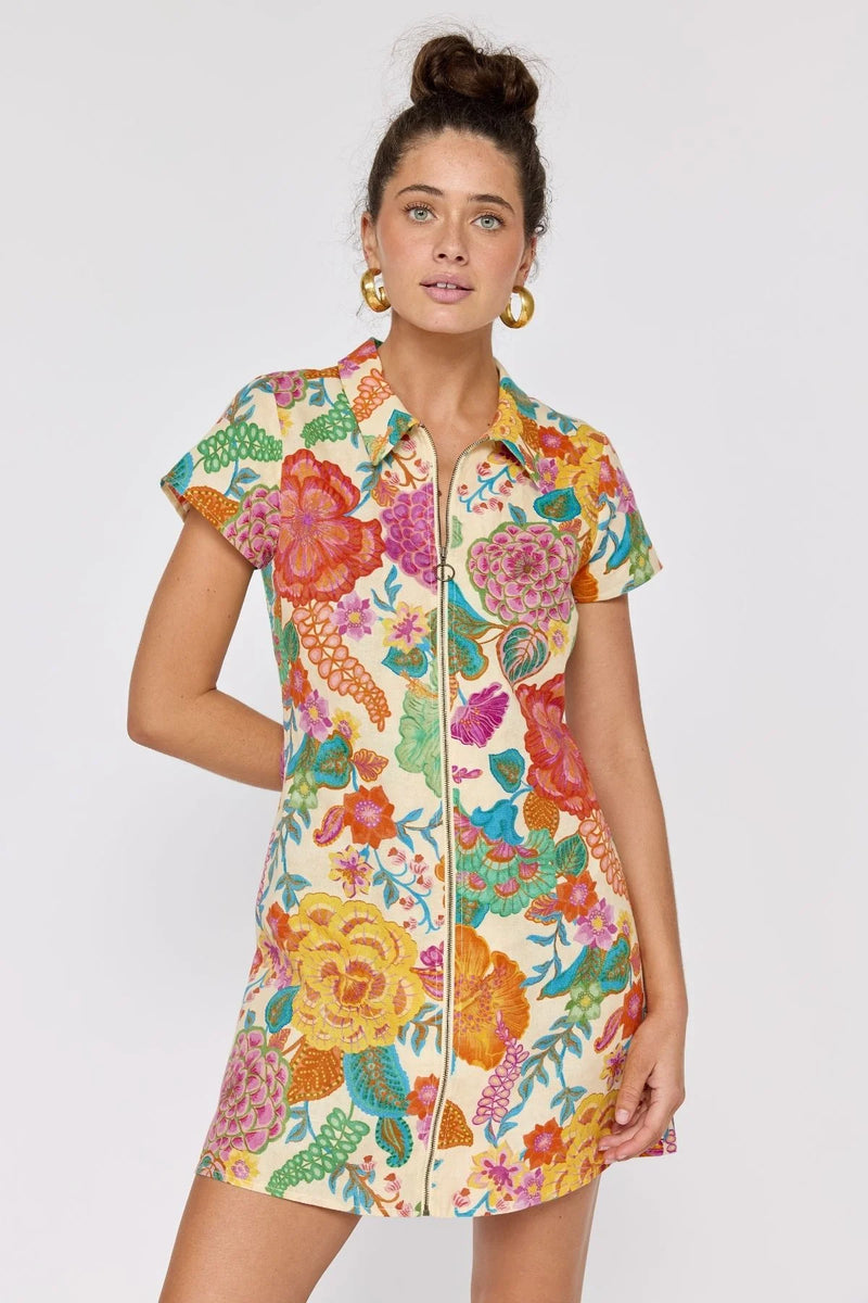Woman wearing a colorful floral dress on a white background