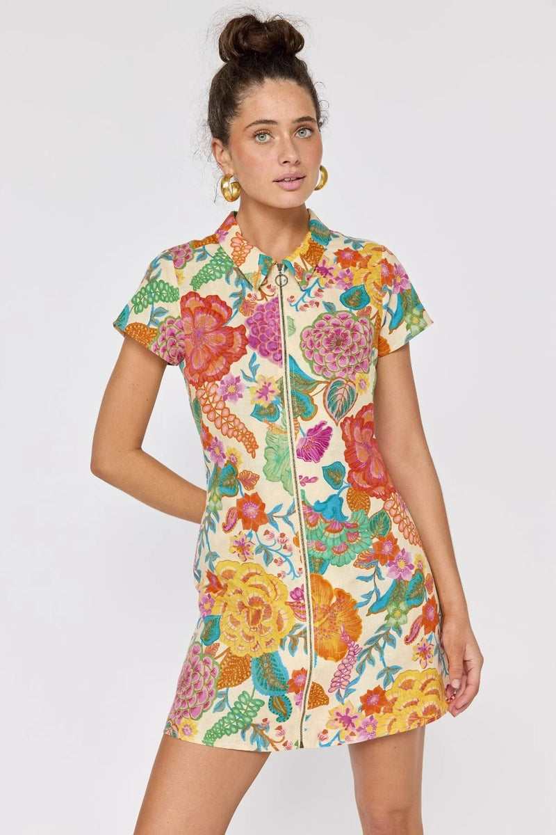 Woman wearing a colorful floral dress on a white background