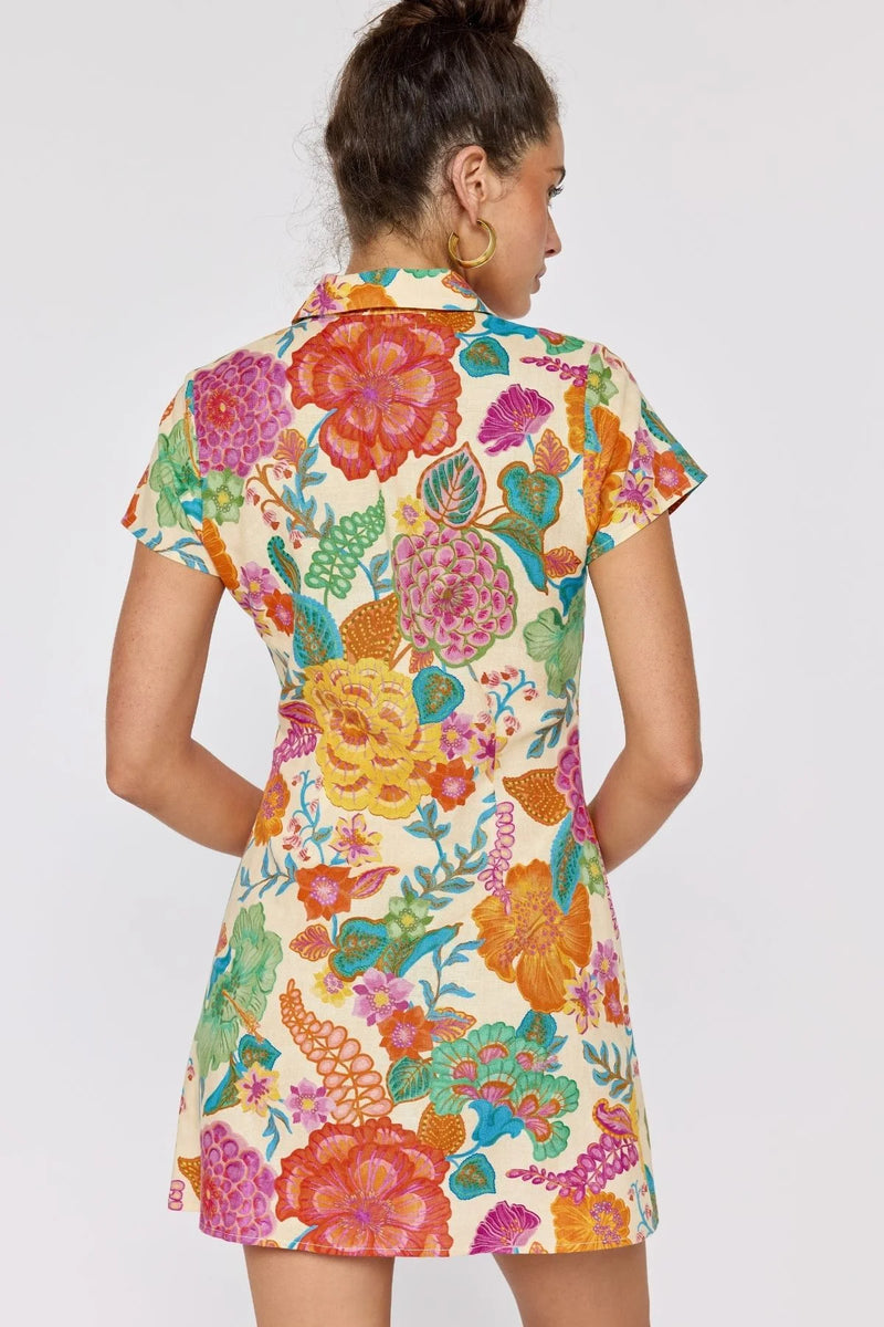 Woman wearing a colorful floral dress on a white background