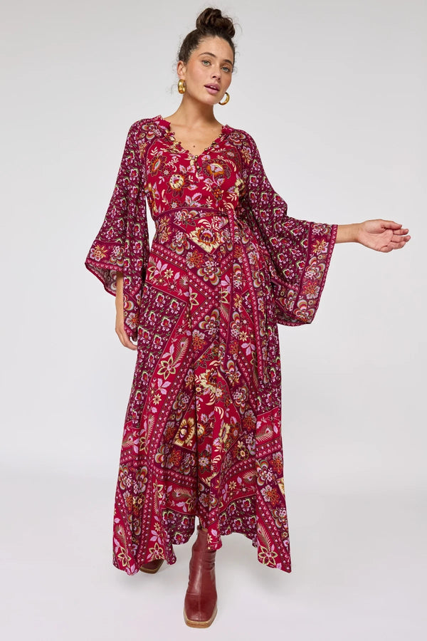 Woman wearing a red floral dress on a white background