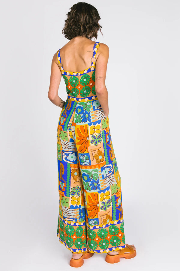 Woman wearing a colorful floral dress on a white background