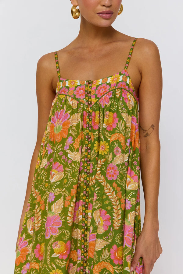 Woman wearing a colorful floral dress on a white background