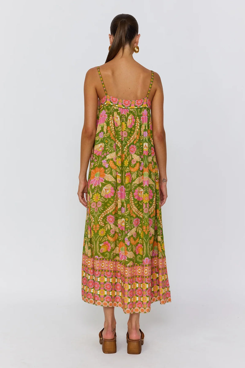 Woman wearing a green floral dress on a white background