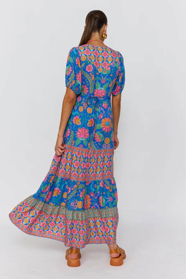 Woman wearing a colorful floral dress on a white background