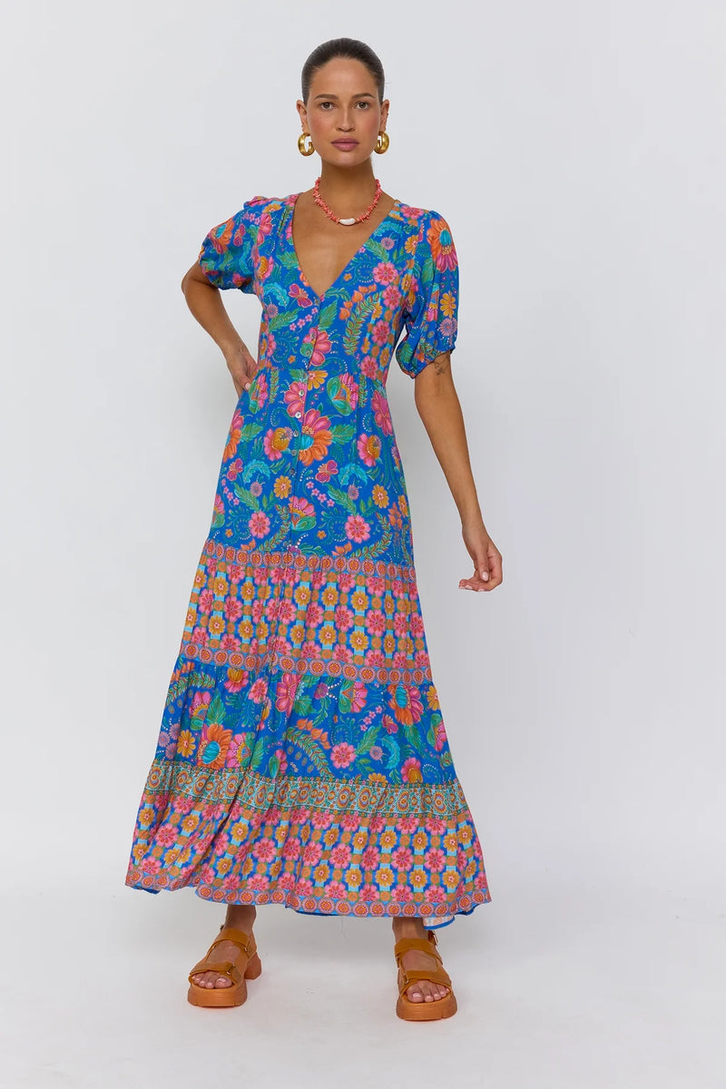 Woman wearing a colorful floral dress on a white background