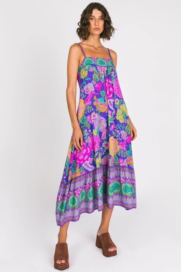 Woman wearing a colorful floral dress on a white background