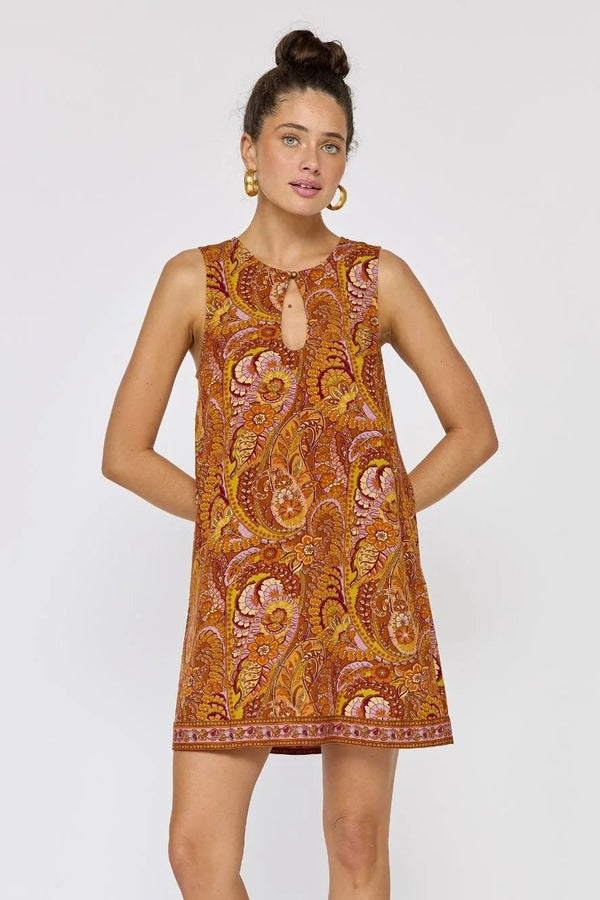 Woman wearing a patterned dress on a white background