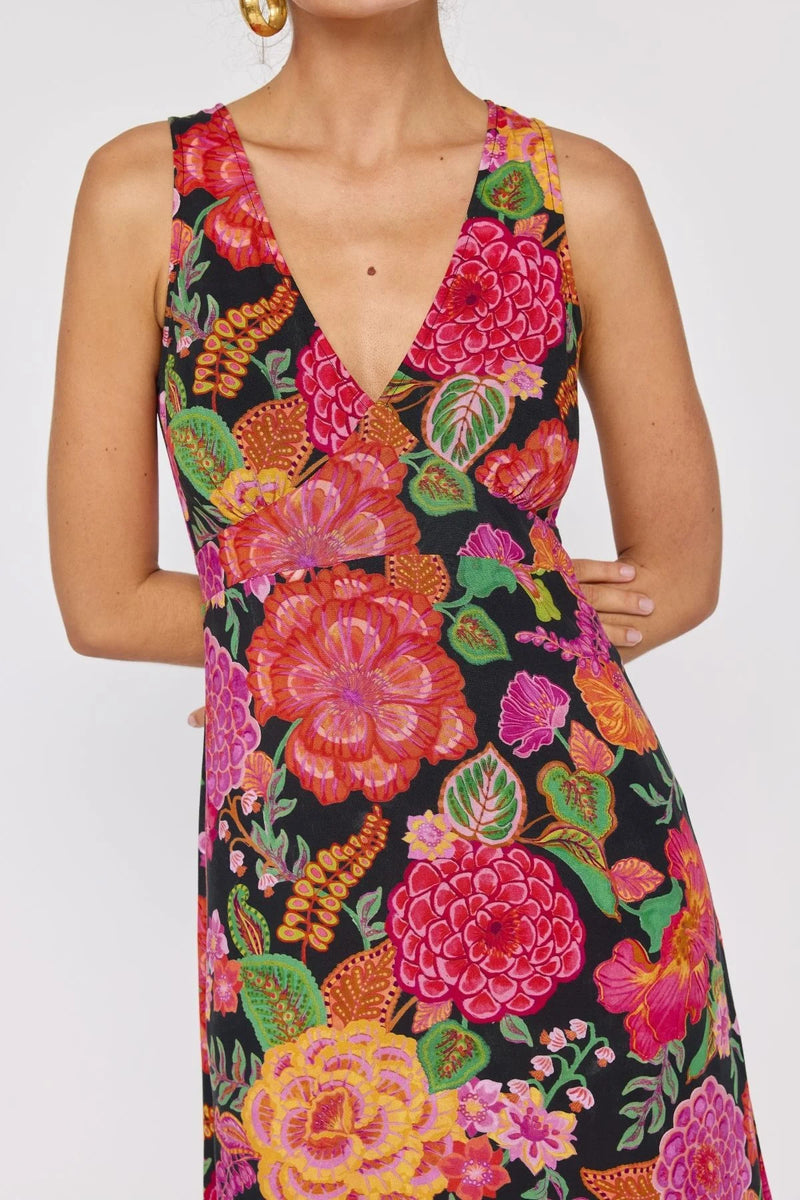 Woman wearing a colorful floral dress on a white background