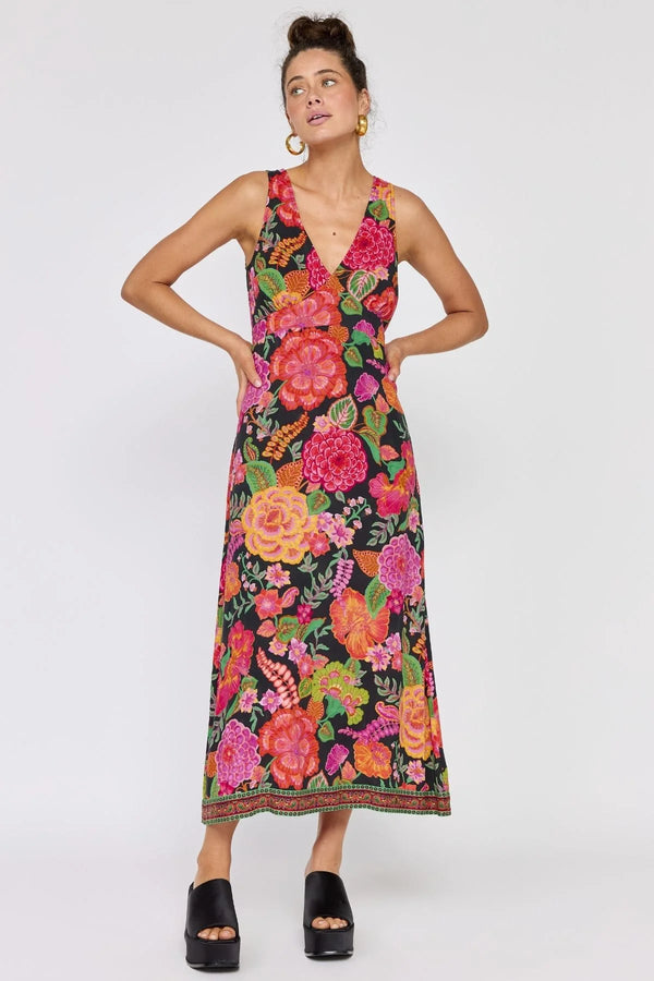 Woman wearing a colorful floral dress on a white background