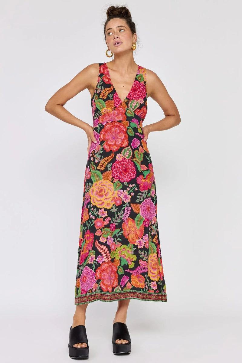 Woman wearing a colorful floral dress on a white background