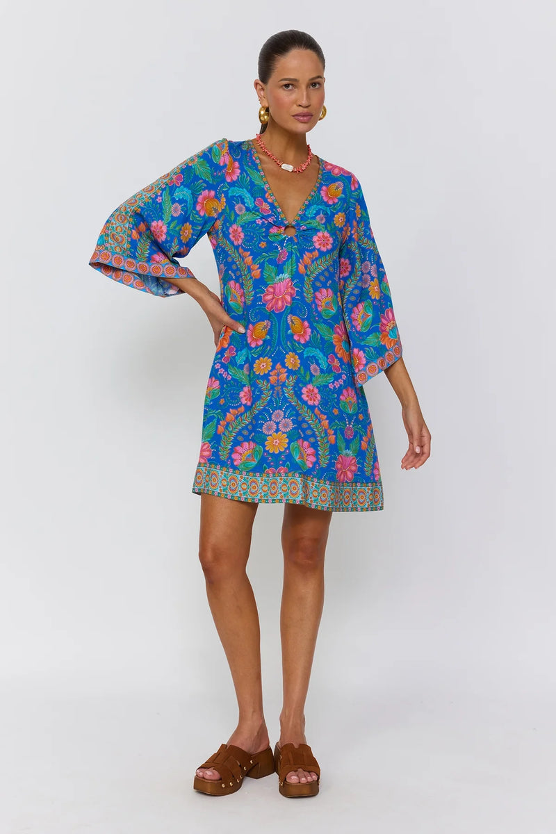 Woman wearing a colorful floral dress on a white background