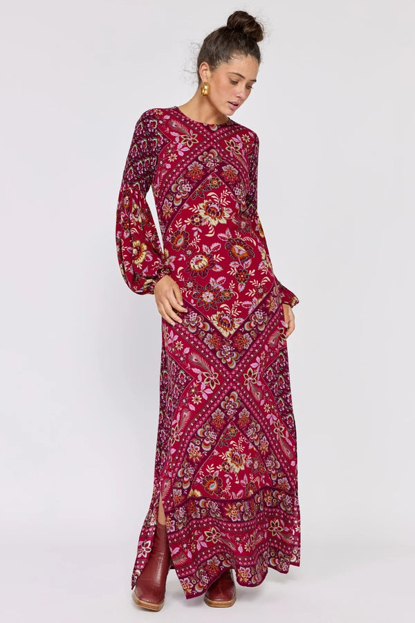 Woman wearing a red patterned dress on a white background