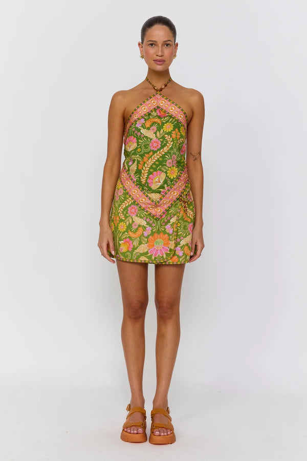 Woman wearing a green floral dress on a white background